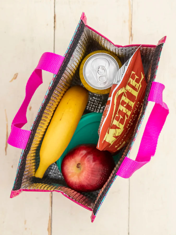 Open cooler bag with banana, apple, can, and snack pack on a wooden surface