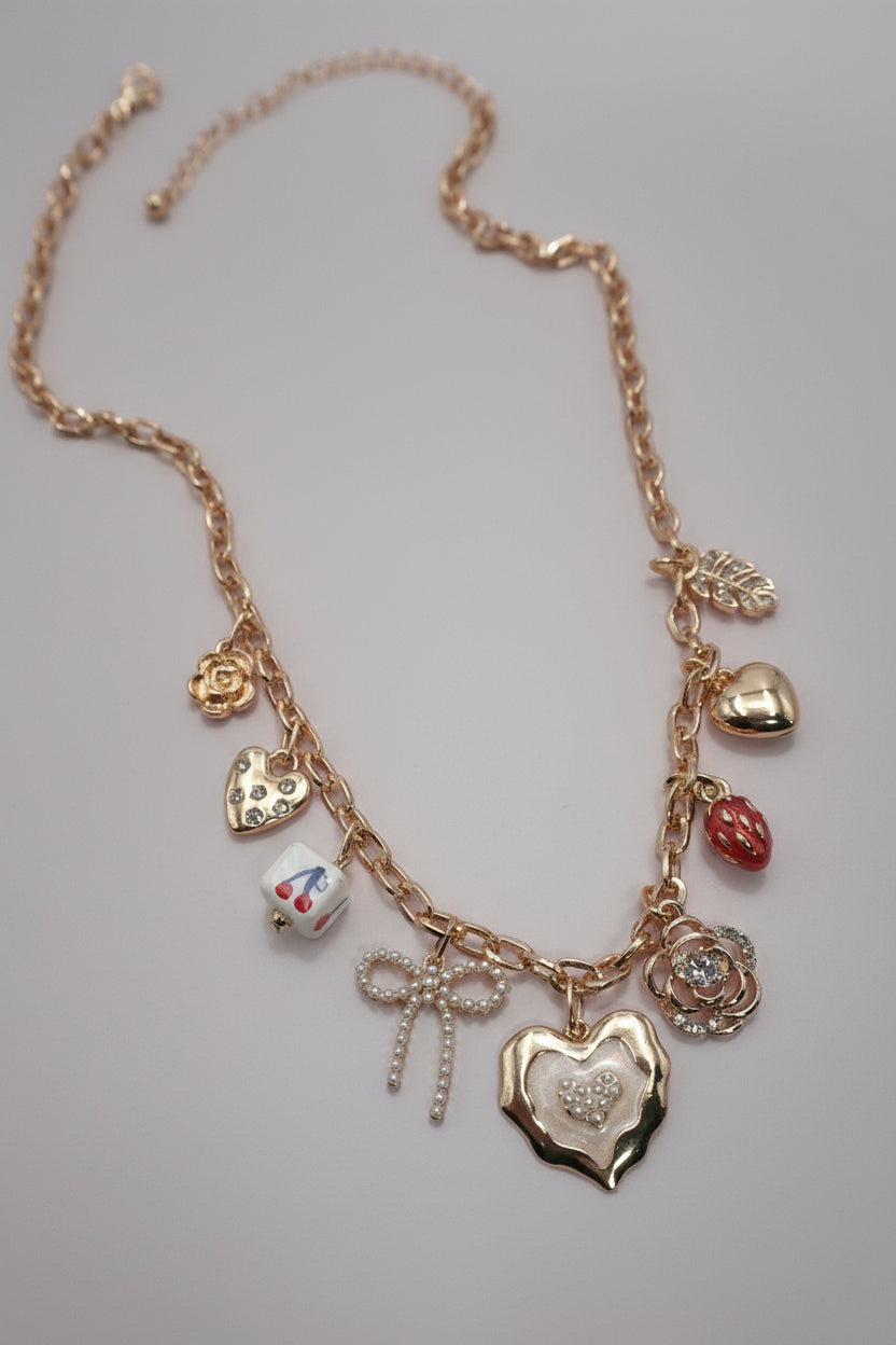 Necklace with various charms on a neutral background