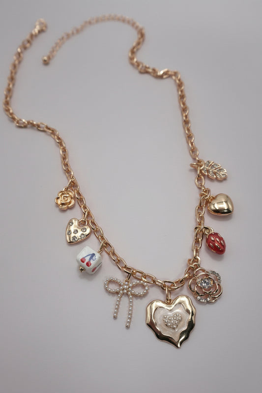 Necklace with various charms on a neutral background
