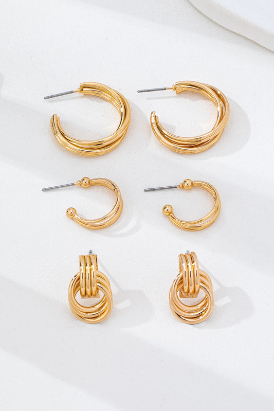 three pairs of gold hoop earrings on a white background