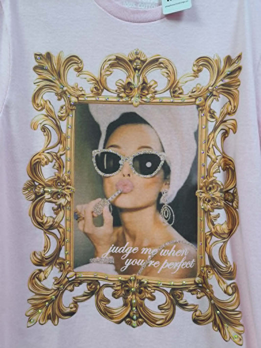 T-shirt with a decorative gold frame and a graphic of a woman with sunglasses and text on a white background.