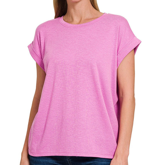 a woman is wearing a lilac magenta stretchy knit top with loose fit and rolled sleeve, front view