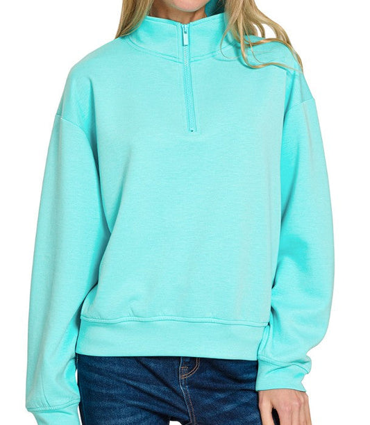 Light blue pullover with a quarter zip on a white background