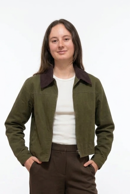 young lady wearing an olive corduroy jacket and a white shirt