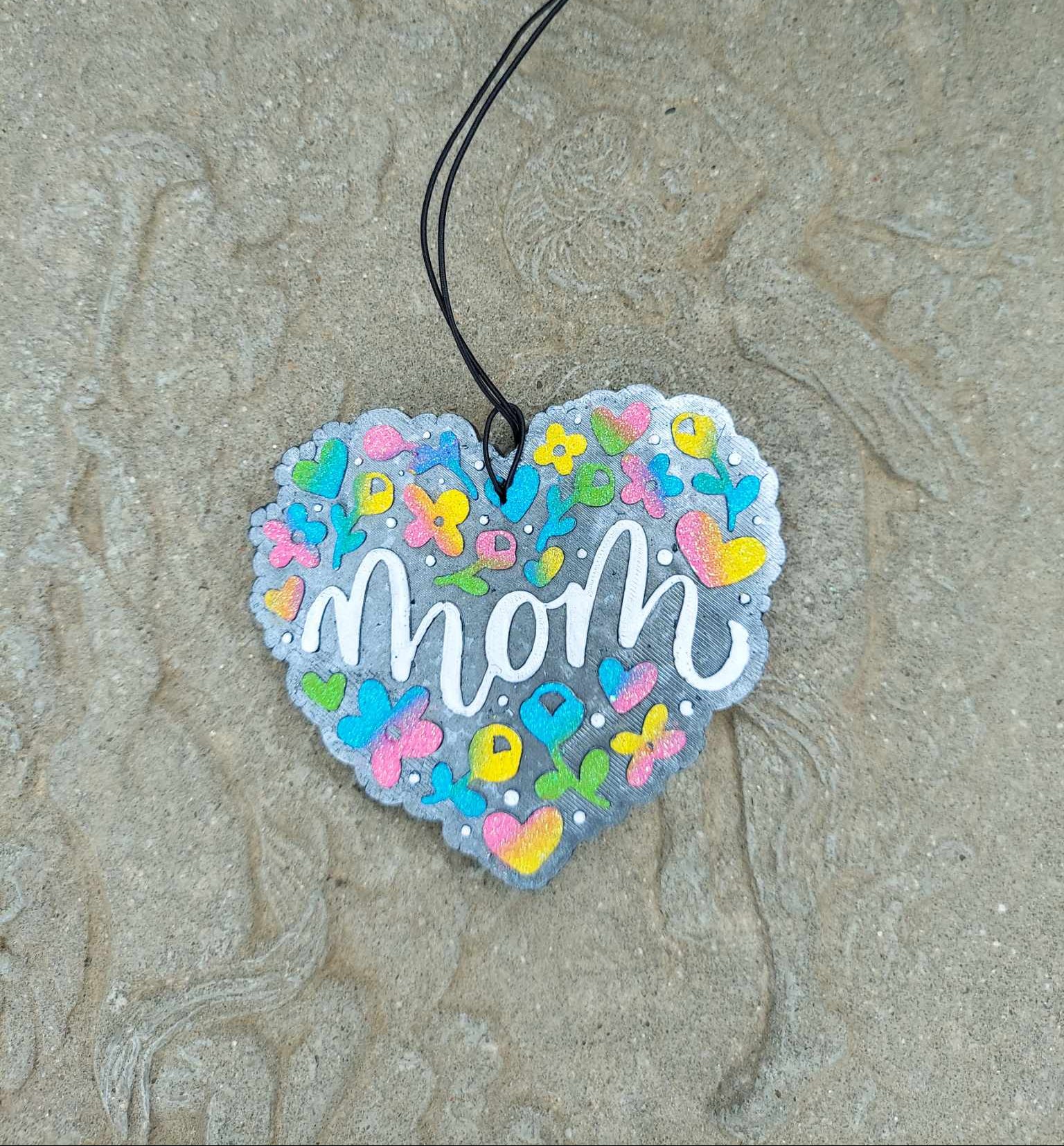 mom heart shaped freshie with colorful flowers on a cement background
