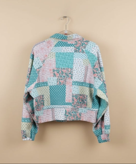 Patchwork quilt on a hanger outdoors