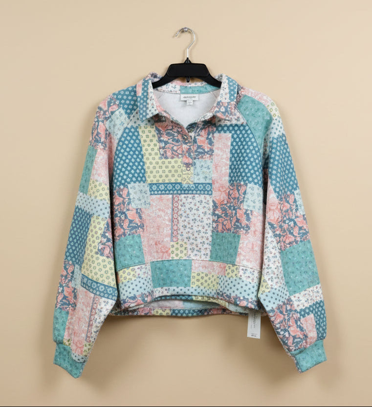 Patchwork shirt on a hanger in a store setting