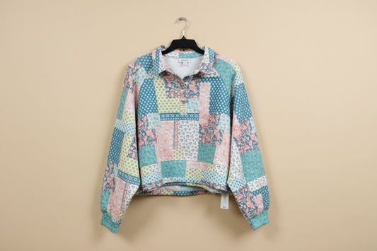 Patchwork shirt on a hanger in a store setting