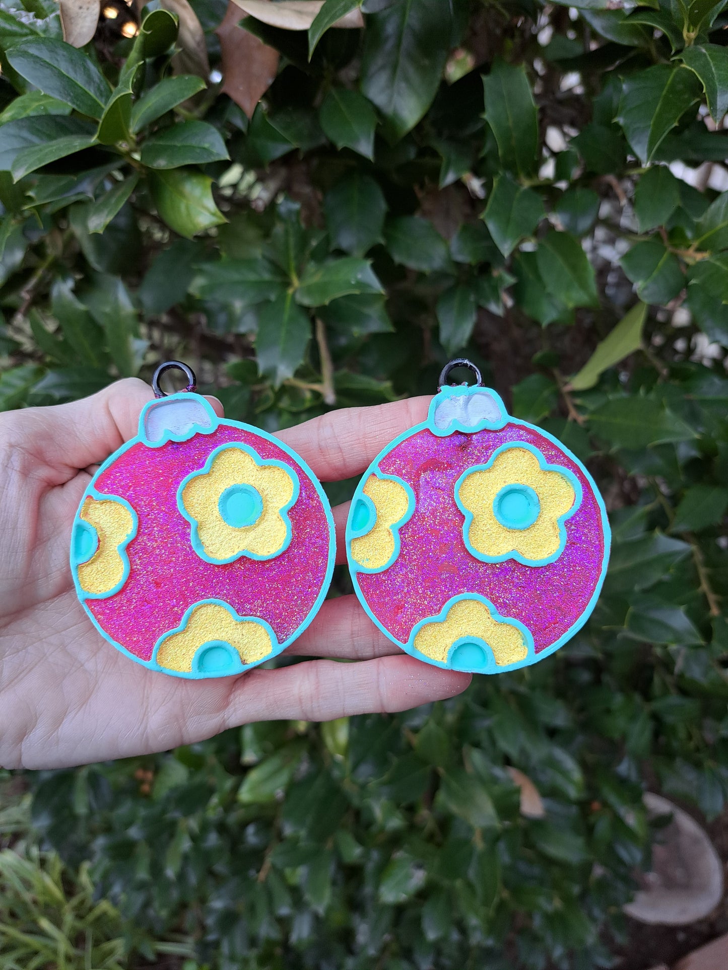 pink yellow vent clip freshies in hand in front of greenery