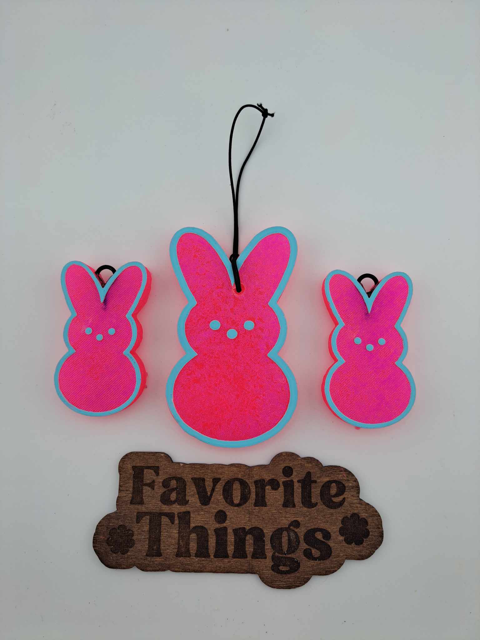 Three bunny air fresheners with blue trim. Says Favorite Things