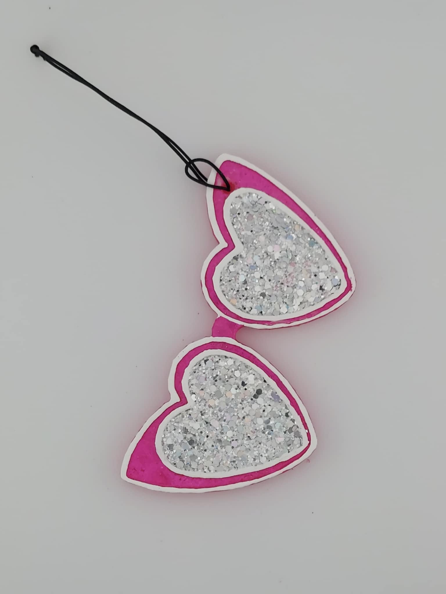 Pink glitter glasses freshie on black string. white background