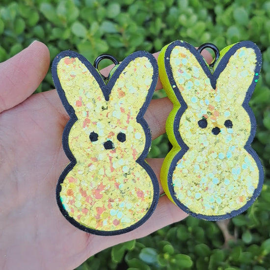 yellow bunny vent clips held on a green leafy background