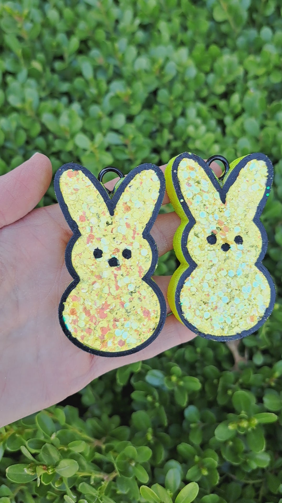 yellow bunny vent clips held on a green leafy background