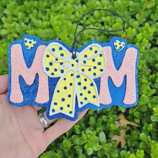 video of a mom freshie with a yellow polka dot bow