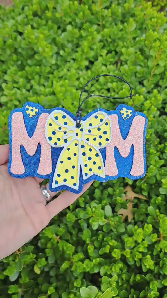 video of a mom freshie with a yellow polka dot bow