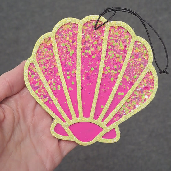 pink shell freshie with glitter held in hand