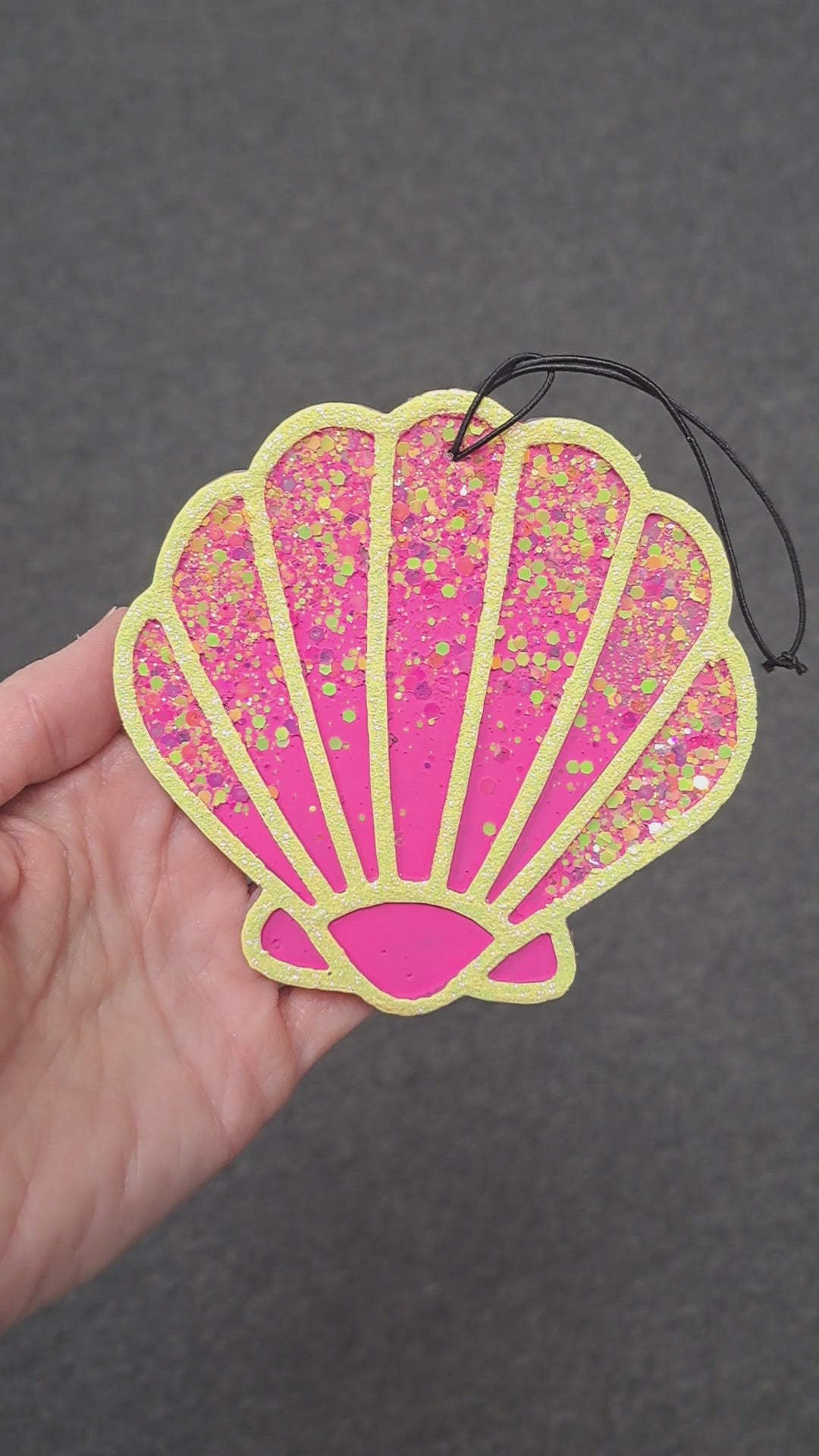 pink shell freshie with glitter held in hand