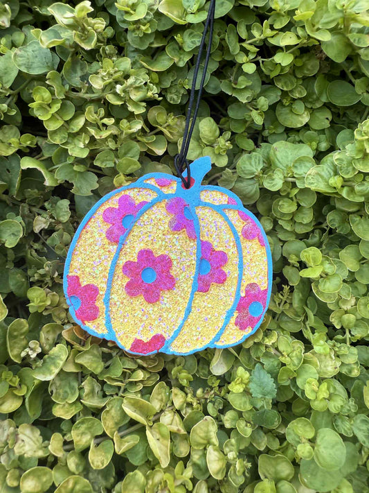 Pumpkin-shaped frehie with pink floral design on a green leaf background