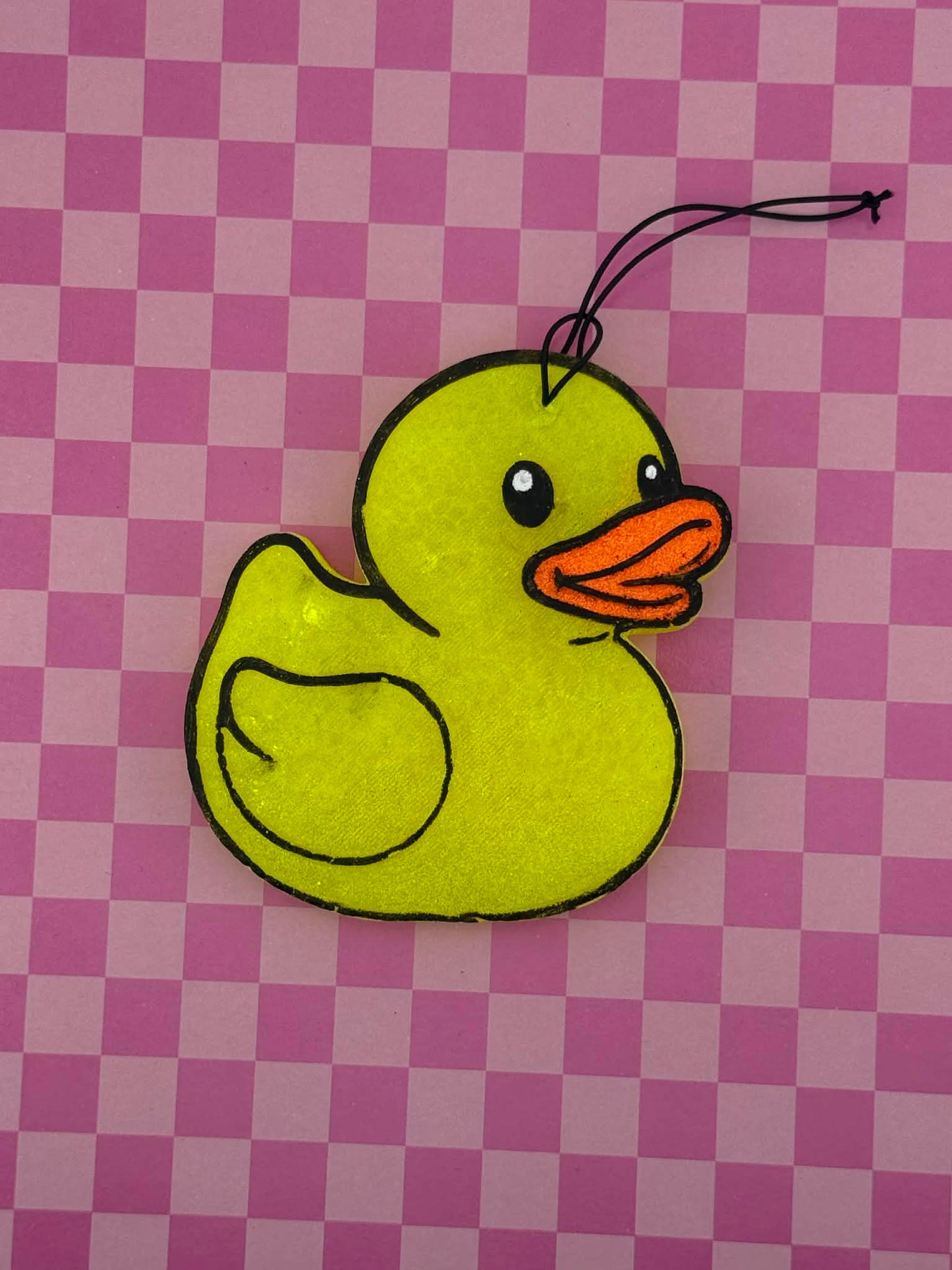 Yellow rubber duck freshie on a pink checkered background