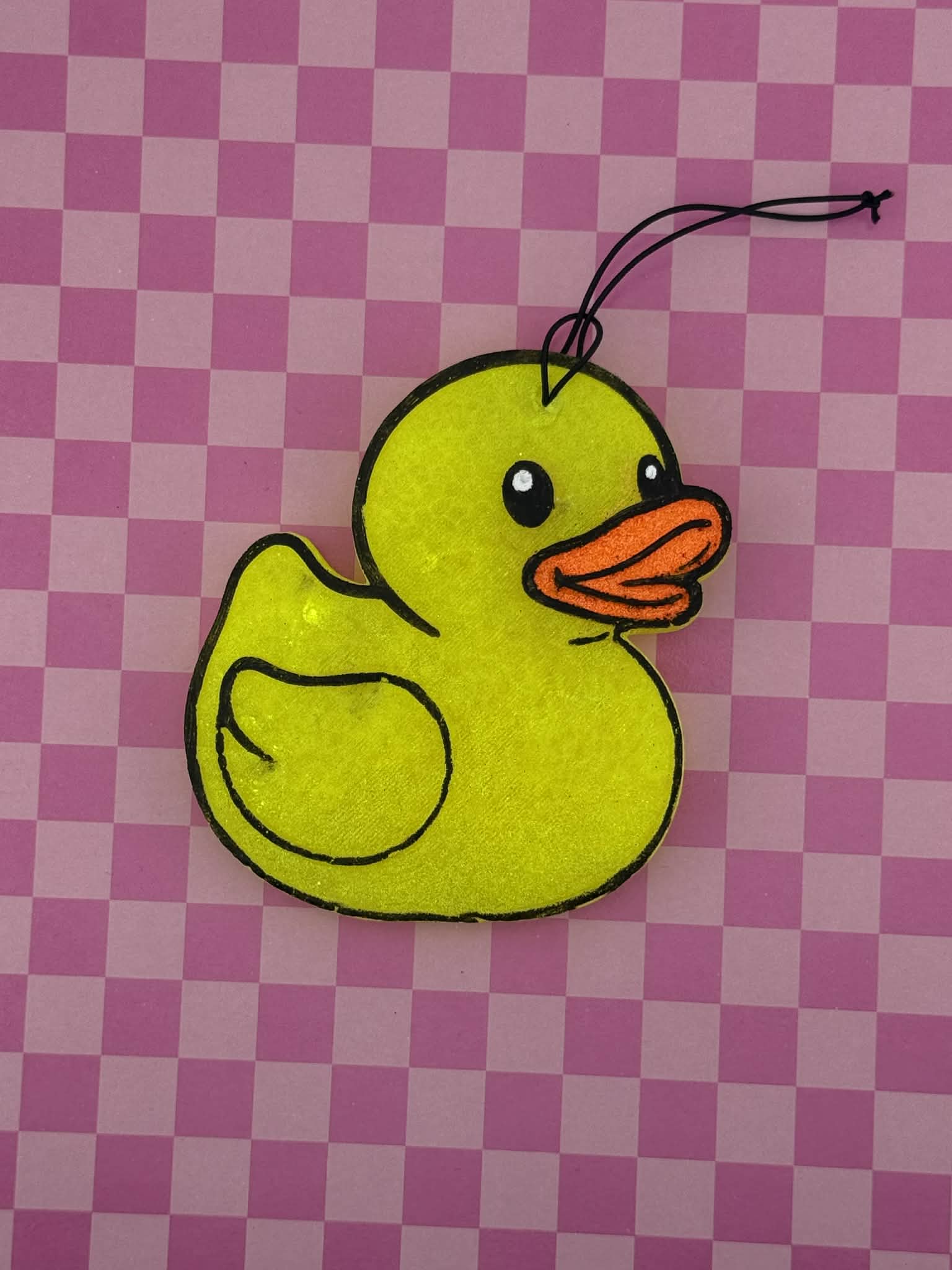Yellow rubber duck freshie on a pink checkered background
