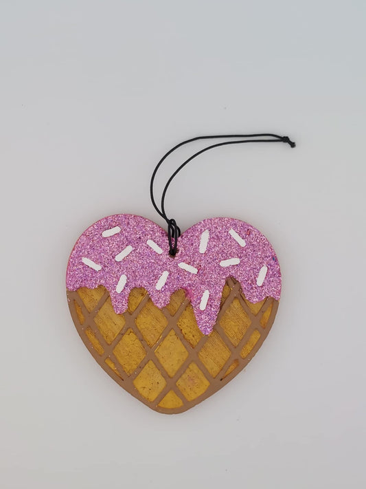A heart-shaped air freshener with a strawberry scoop design, featuring a black elastic string for hanging.