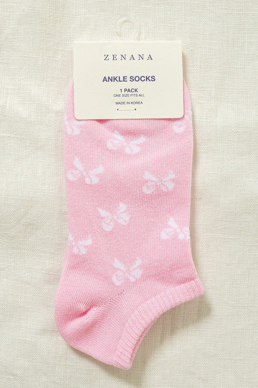 light pink ankle socks with white bow print. Beige background