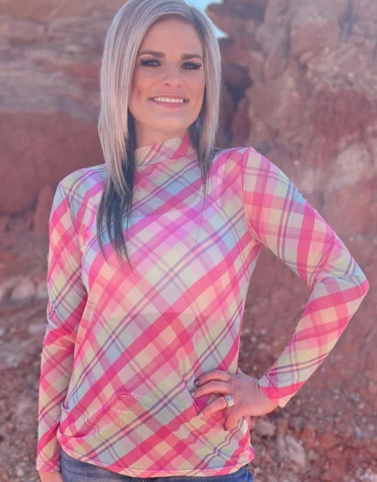 Woman wearing a colorful plaid shirt in a desert setting