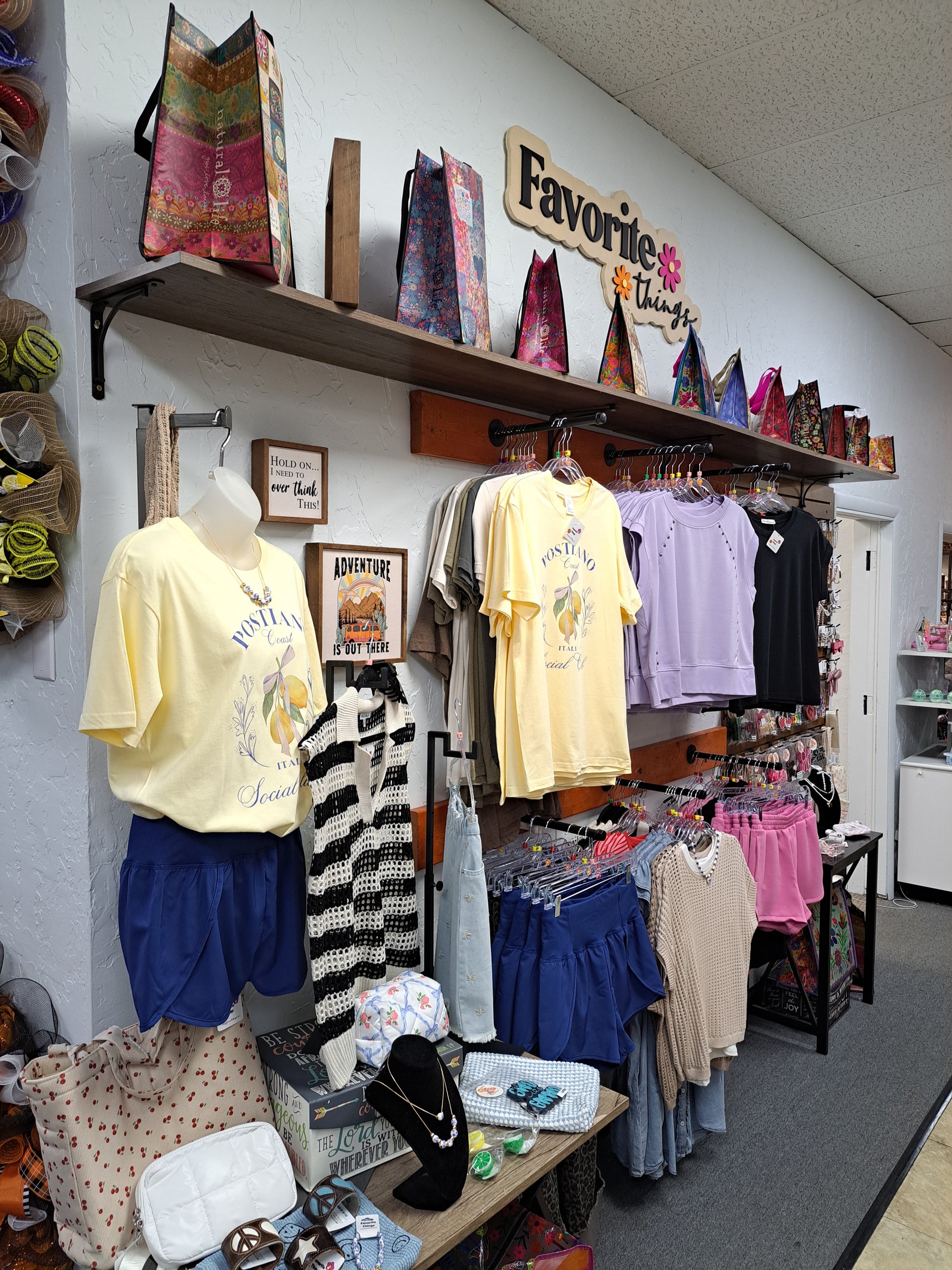 Table with various clothing items and accessories on display.