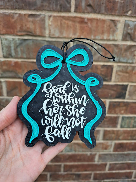 Decorative hanging freshie with teal bow and motivational quote against a brick wall.