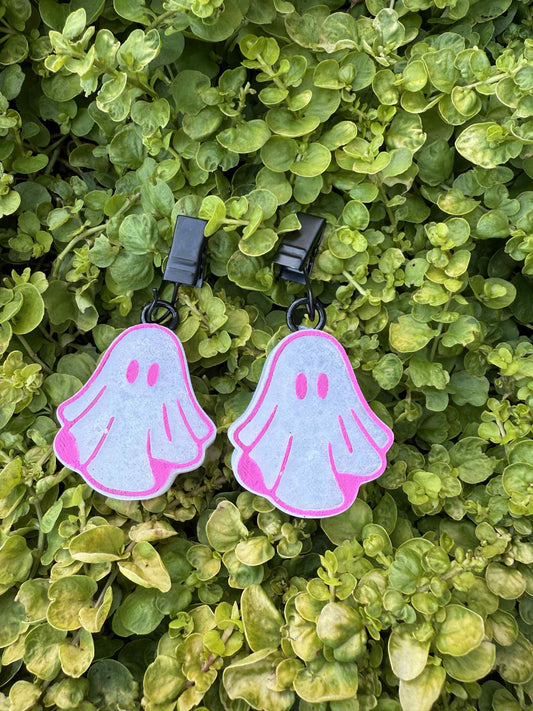 White vent clip ghost shaped air fresheners. Pink trim. Greenery background.