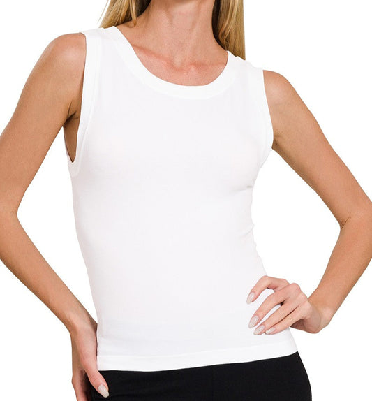 woman wearing a white tank top with black pants on a white background