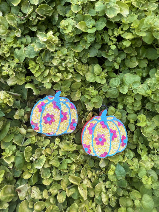 yellow pumpkin vent clips with pink daisies on greenery background