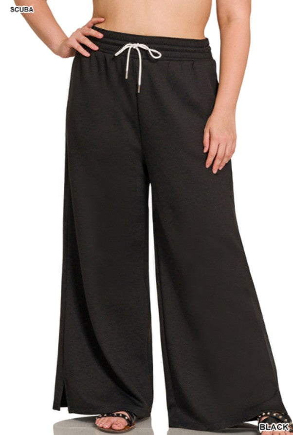 Black wide-leg pants with a drawstring waist on a plain background