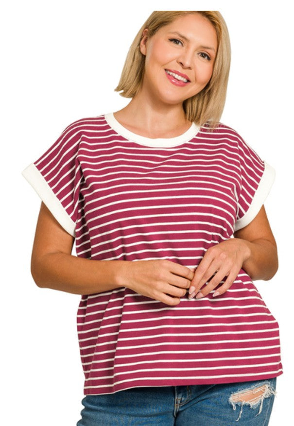 Woman wearing a cabernet red and white striped shirt on a white background