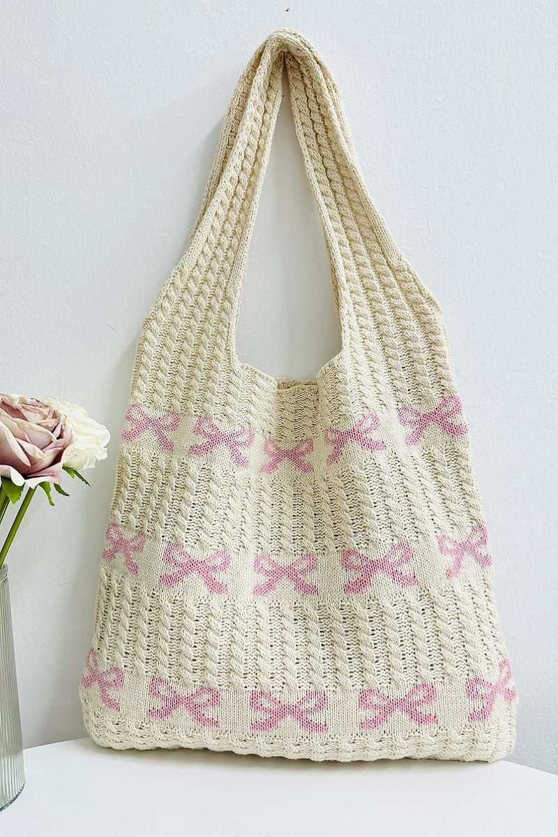 Woven bag with pink bow patterns on a white background