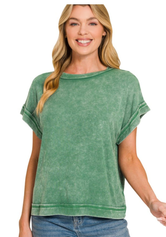 Woman wearing a green rayon top on a white background