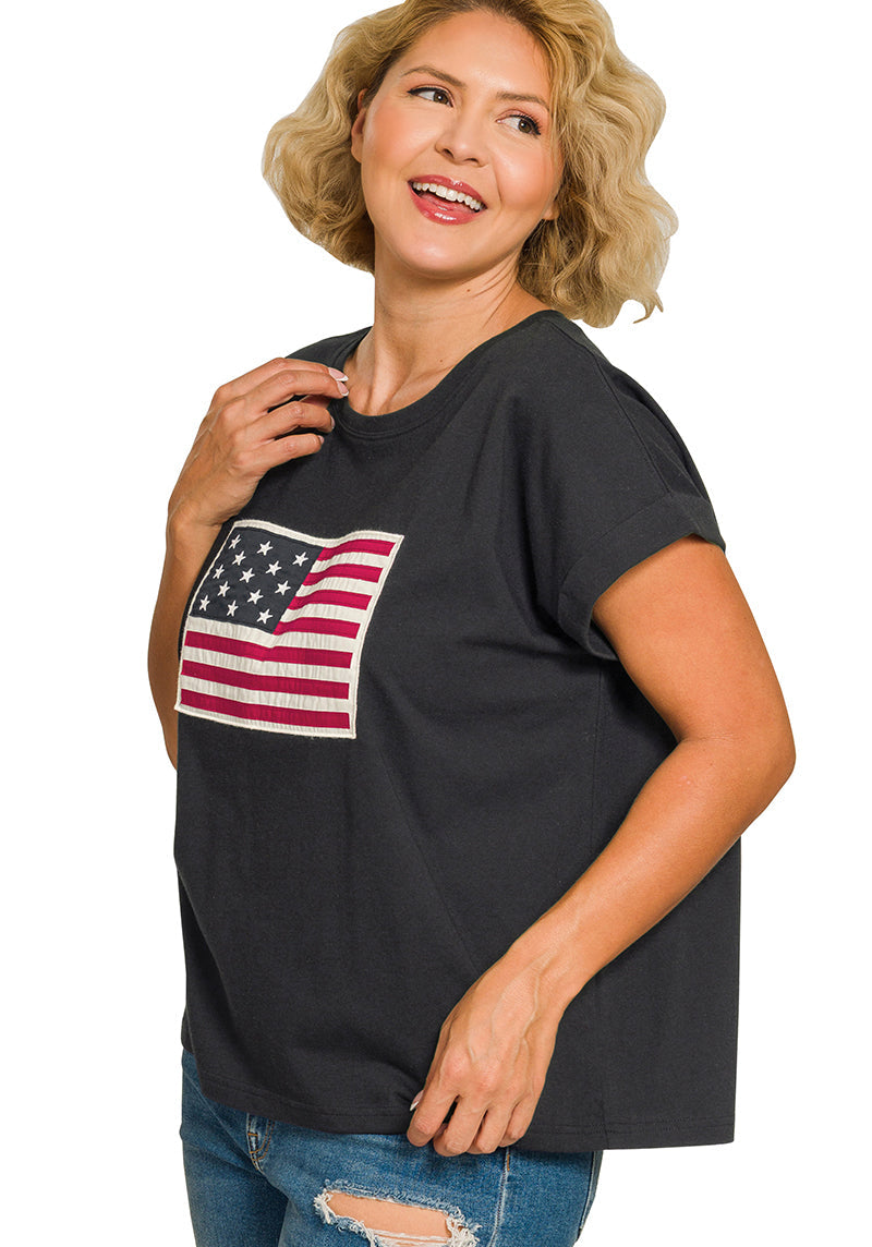 Woman wearing a black t-shirt with an American flag design on a white background