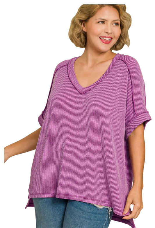 Woman wearing a purple oversized sweater on a white background
