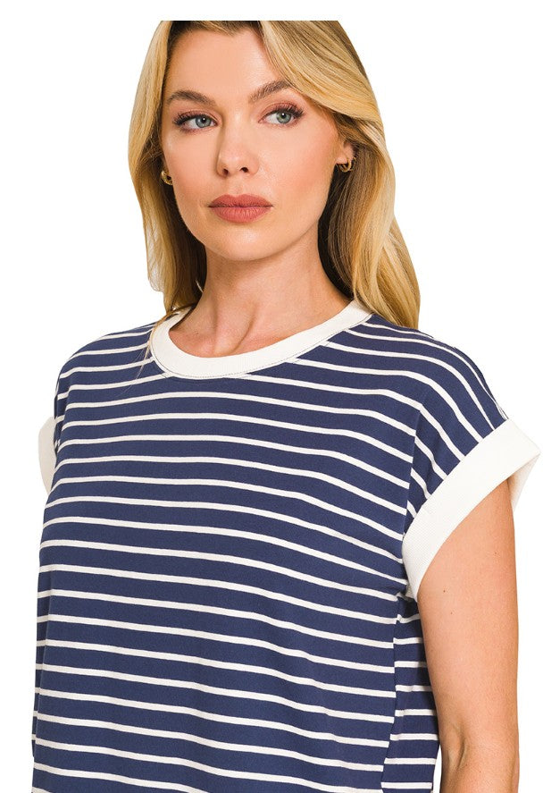 Woman wearing a navy and white striped t-shirt against a plain background
