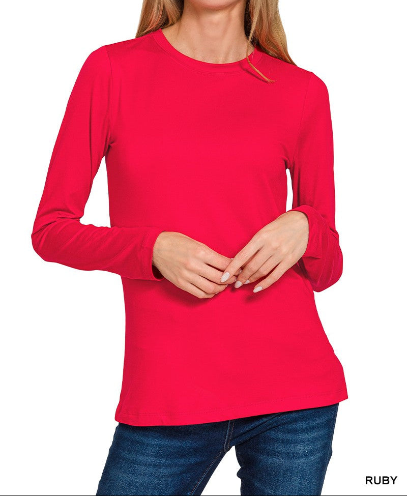 Woman wearing a red long-sleeve top on a white background