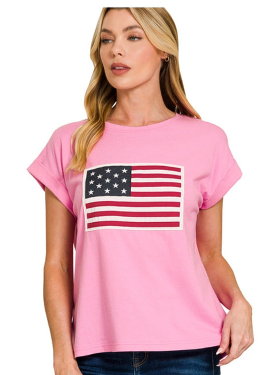 Woman wearing a pink t-shirt with an American flag design on a white background
