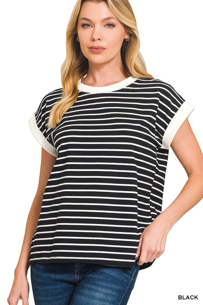 Woman wearing a black and white striped t-shirt with blue jeans on a white background
