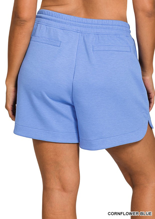Blue shorts worn by a person on a white background