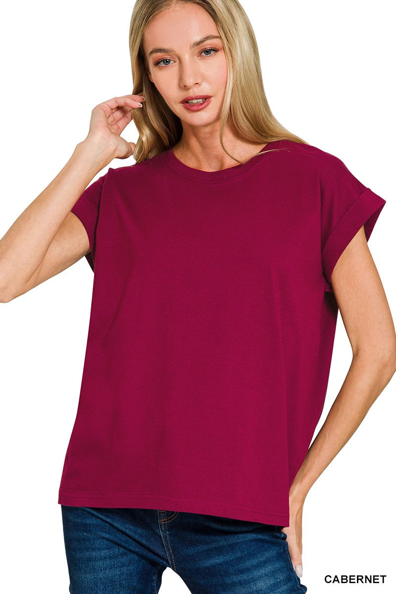 Woman wearing a cabernet-colored top on a white background