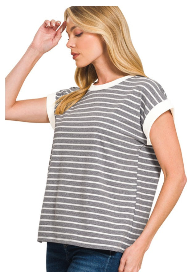 Woman wearing a gray and white striped top on a white background