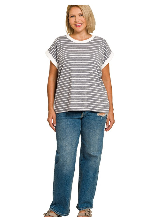 Woman wearing a striped shirt and blue jeans on a white background
