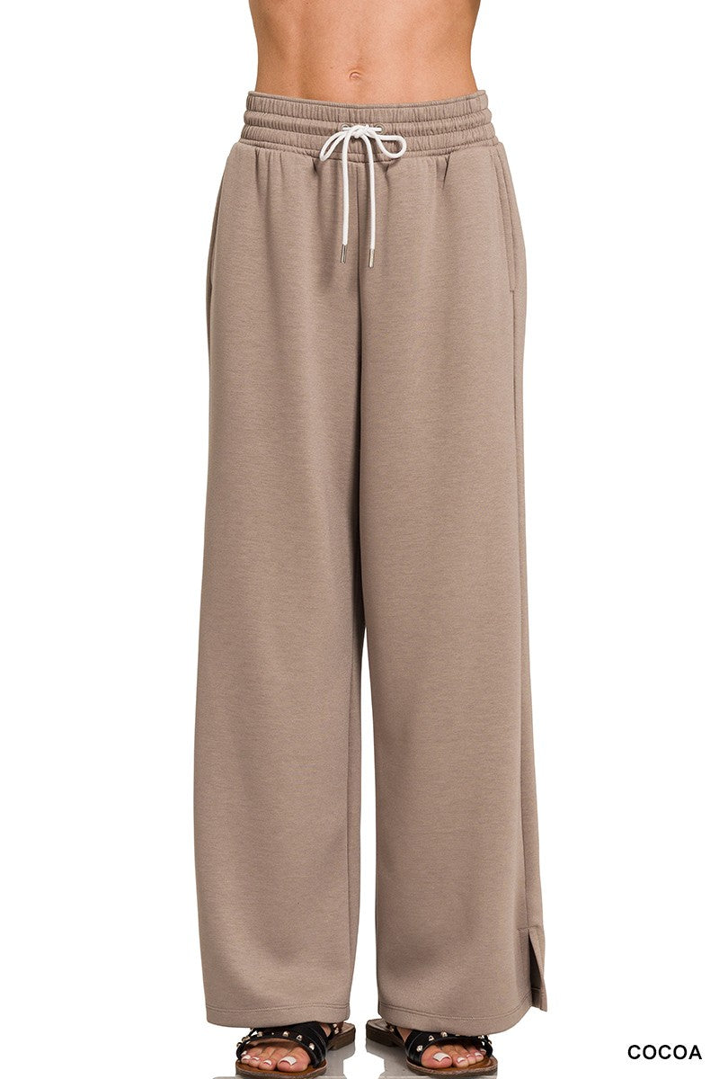 Beige wide-leg pants with a drawstring waist on a white background