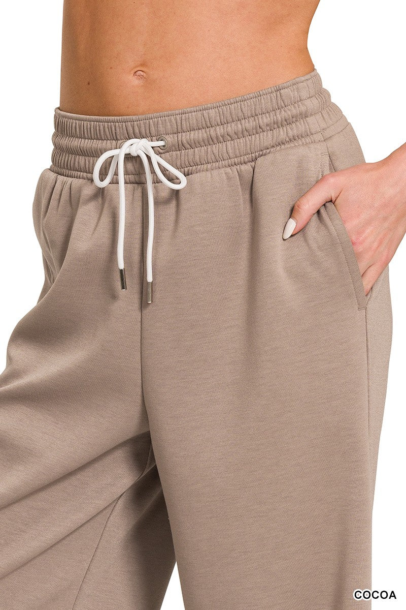 Beige sweatpants with a drawstring on a white background