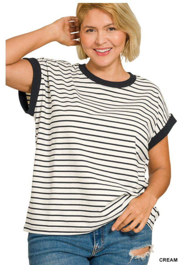 Woman wearing a black and white striped shirt with blue jeans on a white background