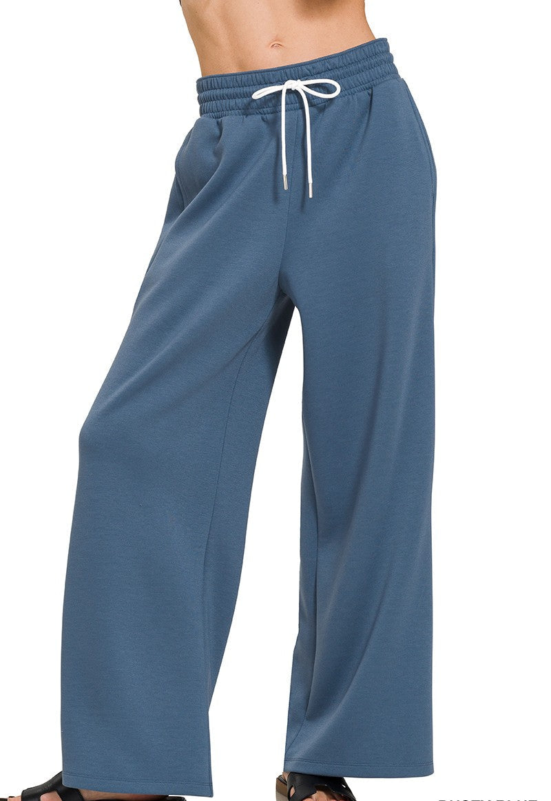 Dusty blue pants with a drawstring on a white background